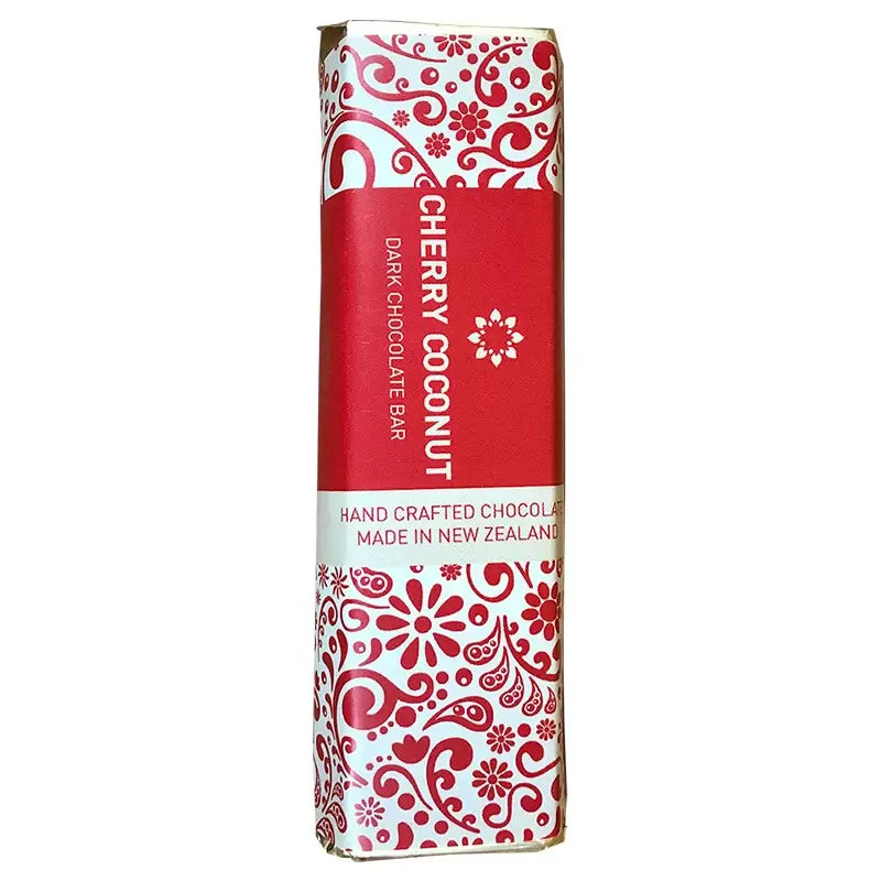 A Celebrate package of handcrafted chocolate with cherry coconut flavor, made in New Zealand, wrapped in a red and white decorative paper, presented by giftbox co.