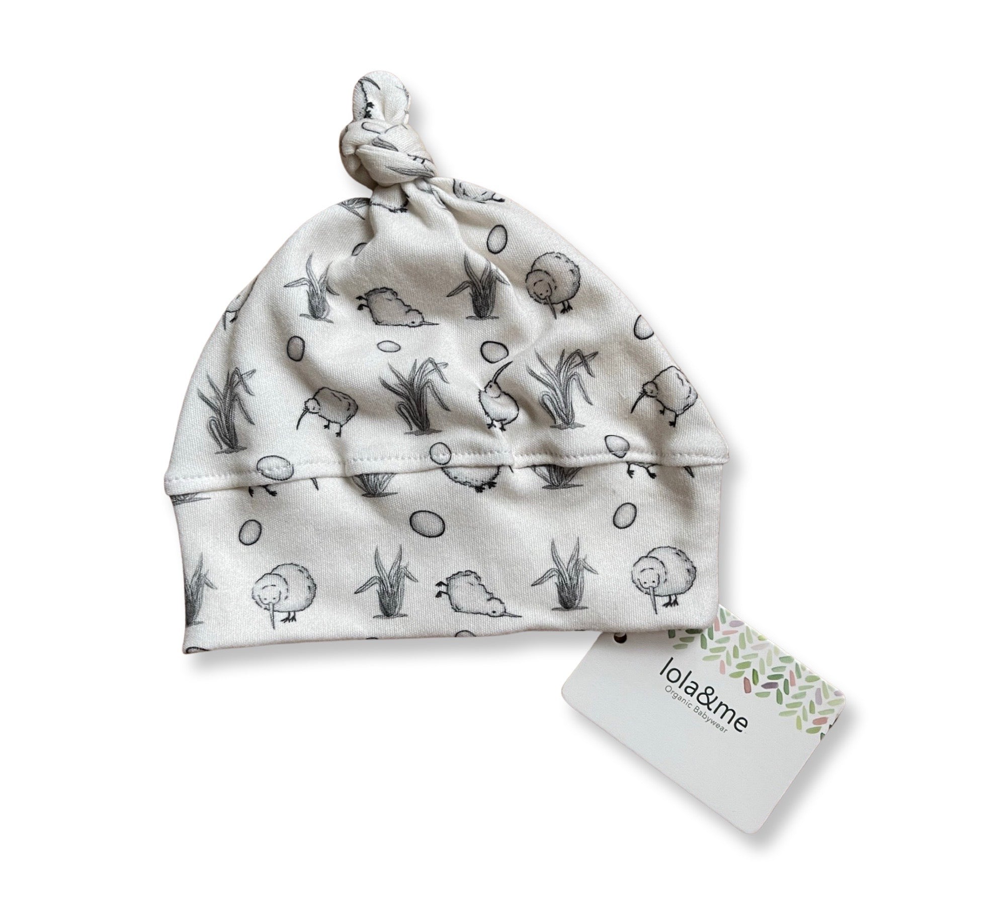 A soft, New Arrival newborn baby beanie with a cute woodland animal print on a white background, displayed next to its product tag, perfect as part of a giftbox co. newborn baby giftbox.