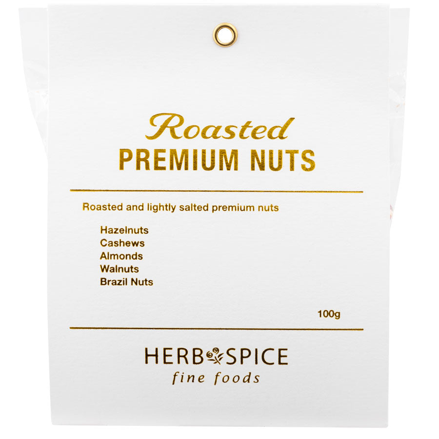 A white label with golden text that reads "Celebrate - lightly salted premium nuts" listing hazelnuts, cashews, almonds, and brazil nuts as contents from giftbox co. by herb & spice fine