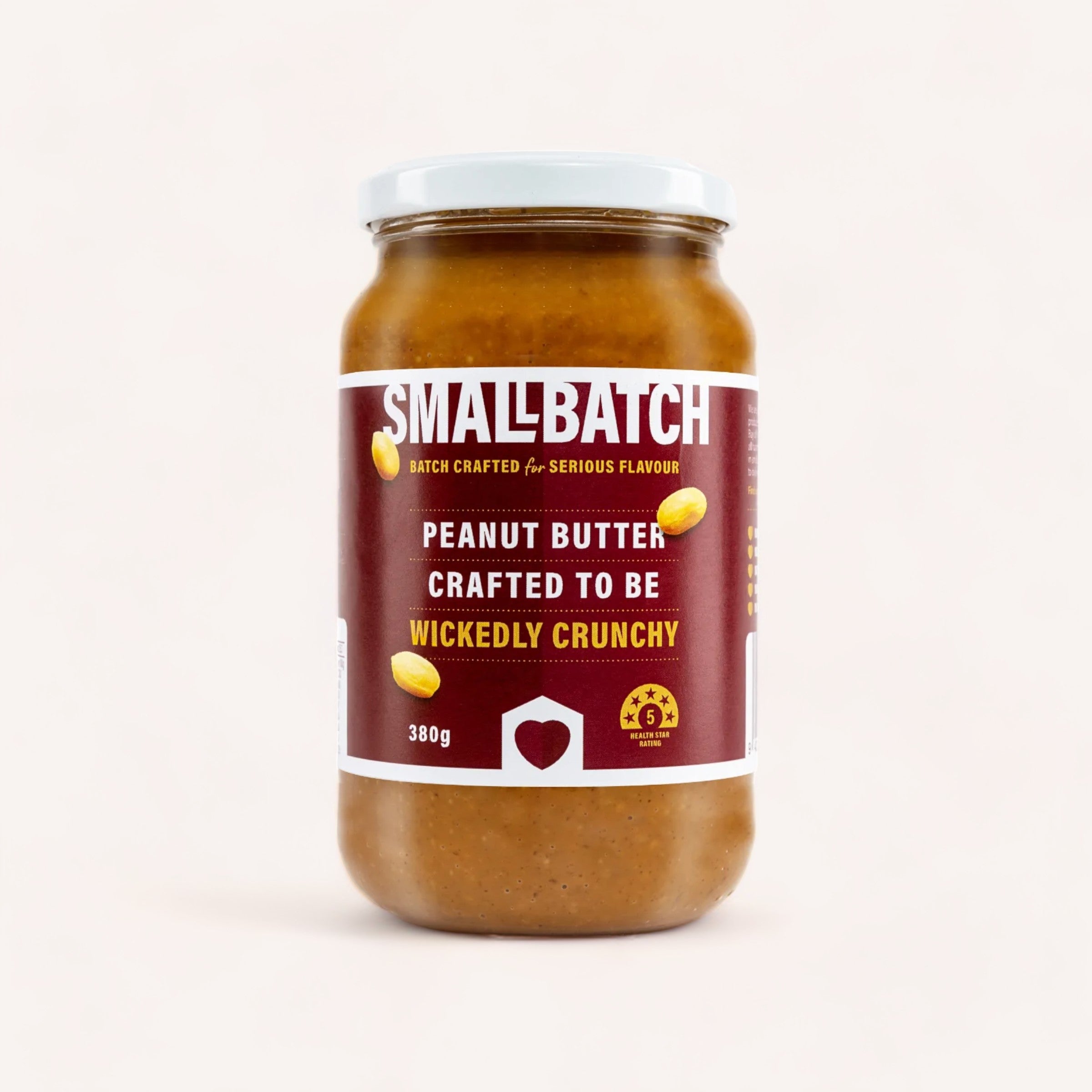 A jar of Spread the Love chocolate hazelnut butter by Smallbatch with a label stating "crafted to be wickedly crunchy" against a neutral background.