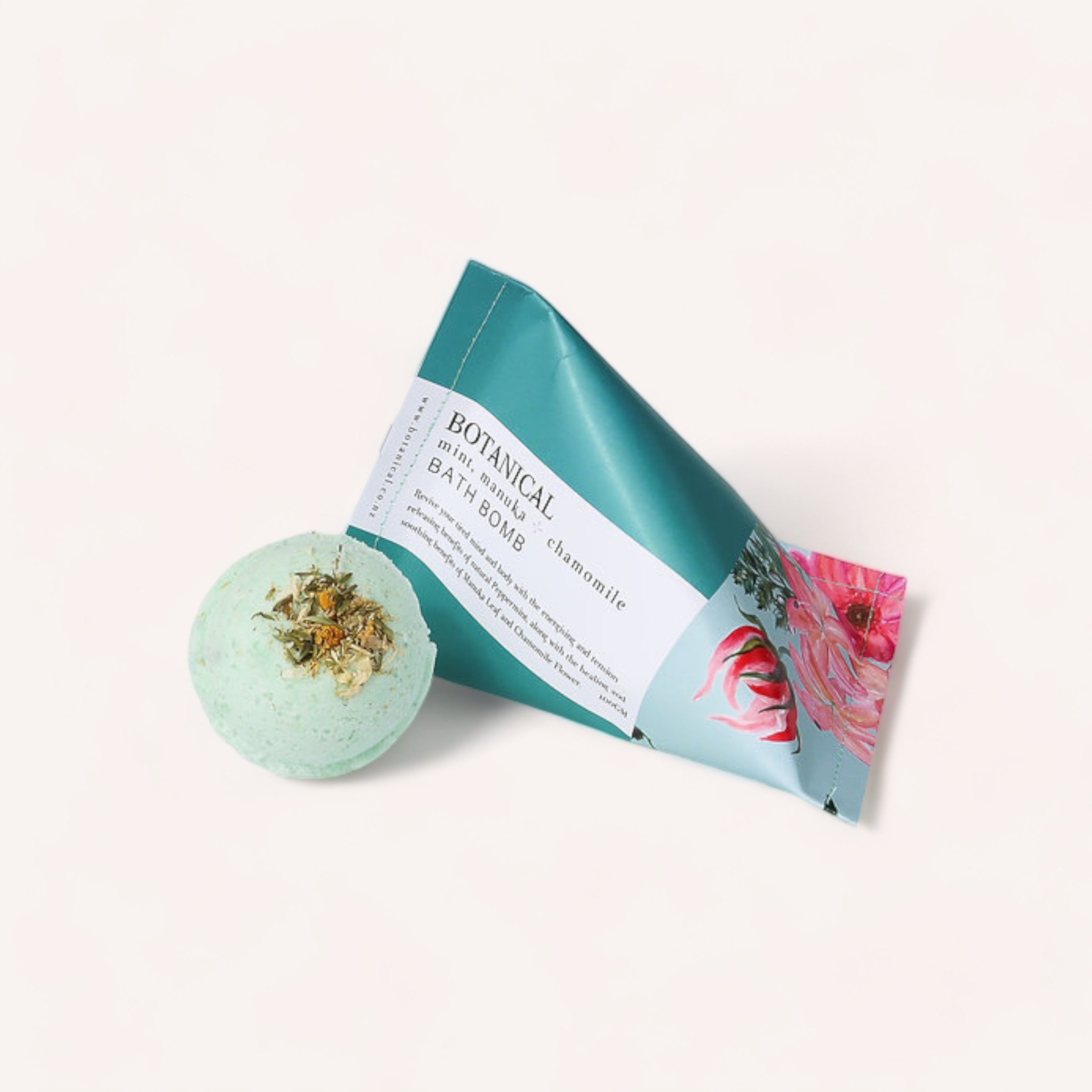 A Mint, Manuka & Chamomile Bath Bomb by Botanical Skin Care and its packaging on a clean, white background.