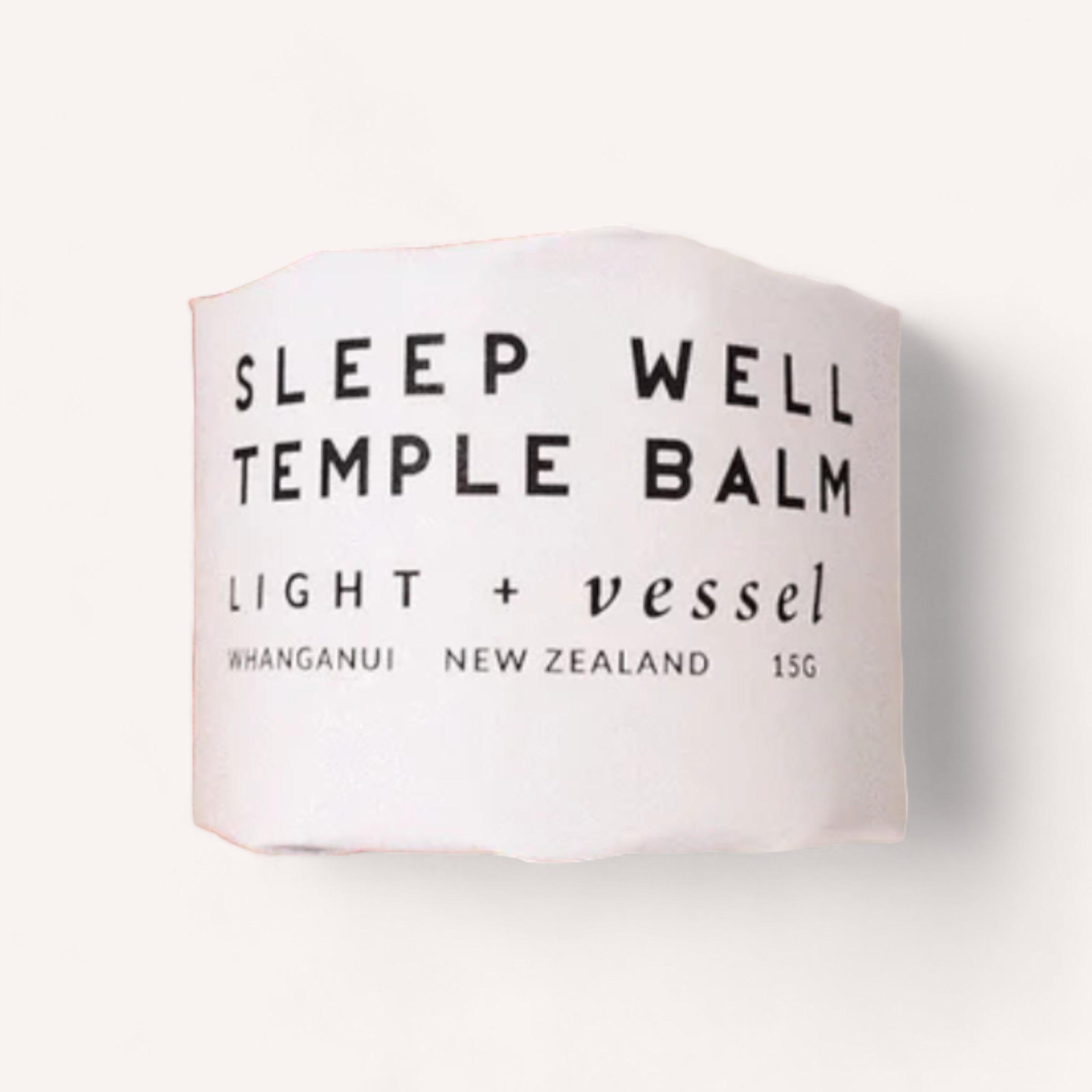 A jar of "Sleep Well Temple Balm" by Light + Vessel, 15 grams, with minimalist labeling, containing lavender essential oil and likely a product made in Whanganui, New Zealand.