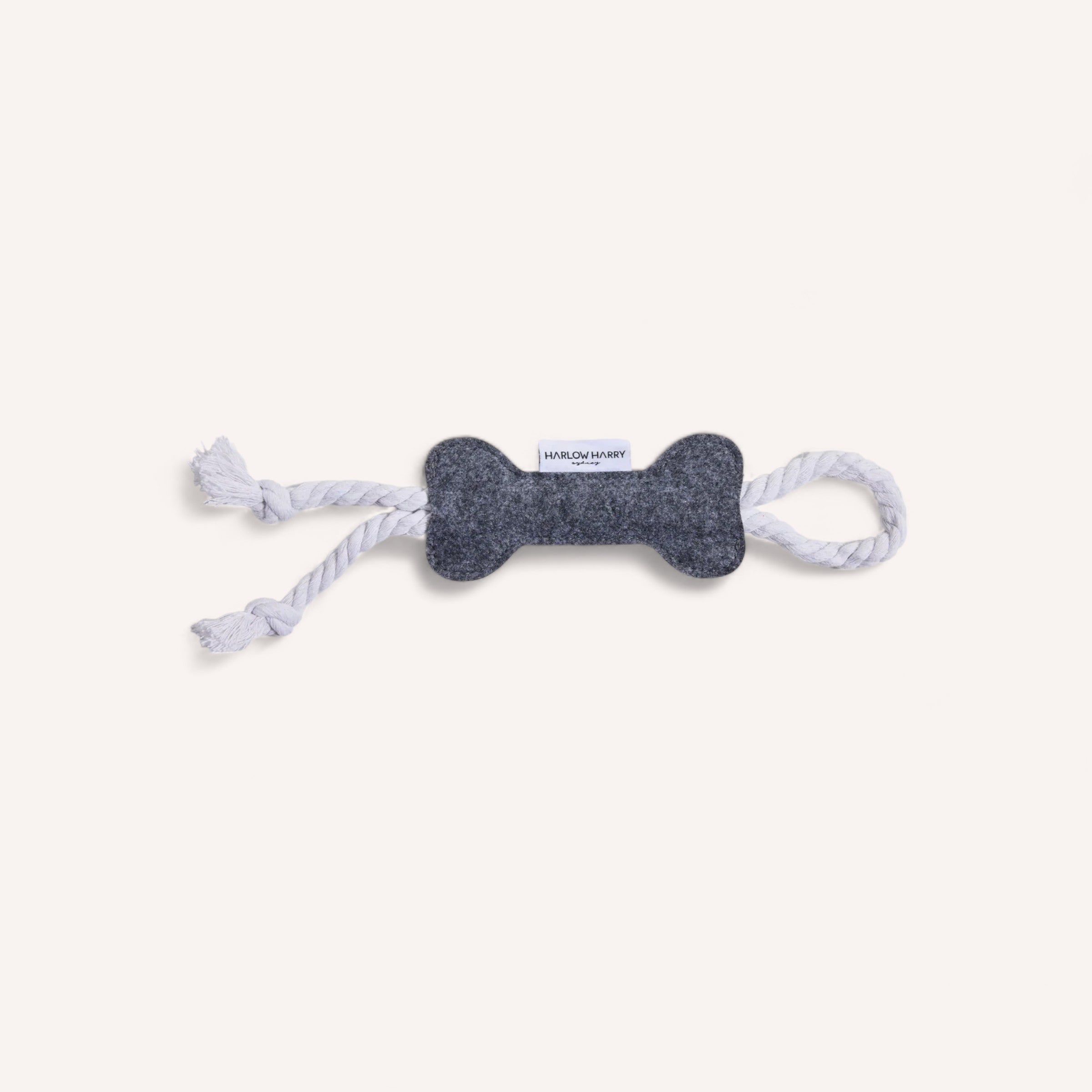 A Rope Felt Bone Toy by Harlow Harry with white rope detail ends on a white background, Product of Australia.