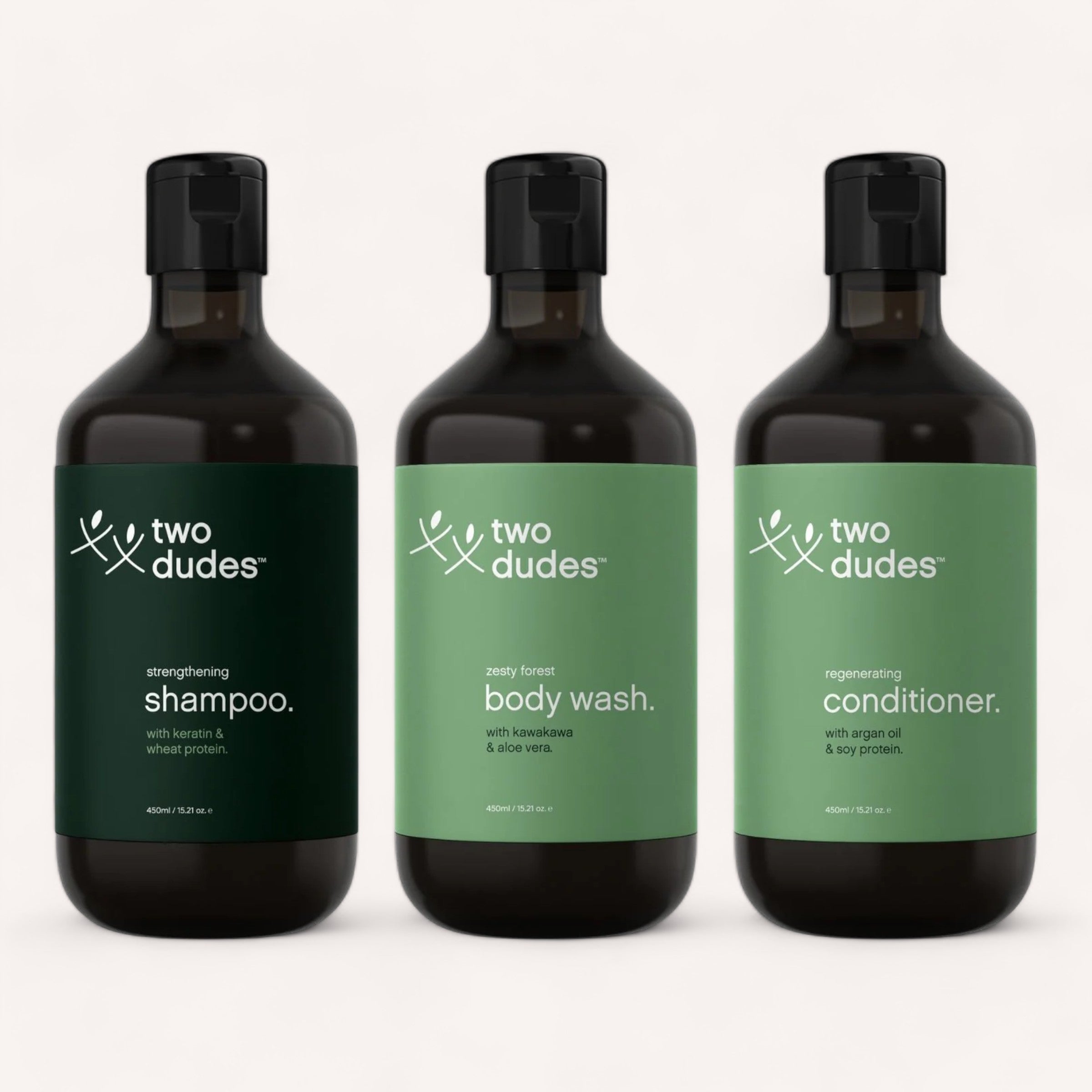 Three bottles of Two Dudes Bundle, including strengthening shampoo, zesty forest body wash, and regenerating conditioner, lined up against a white background.