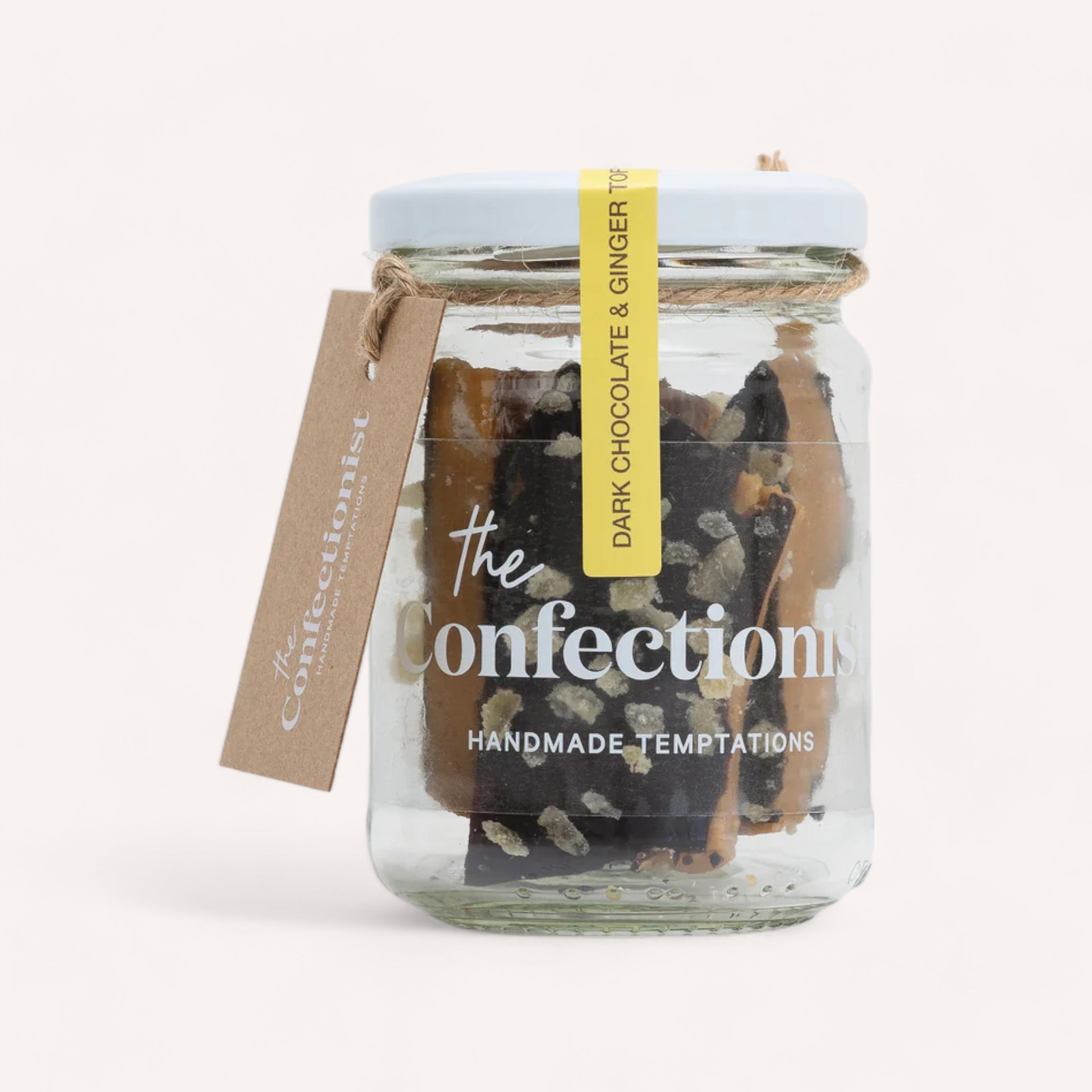 A glass jar filled with Ginger Dark Chocolate Toffee by The Confectionist, labeled "the confections - handmade temptations," sealed with a yellow band and a brown tag reading "chocfections.