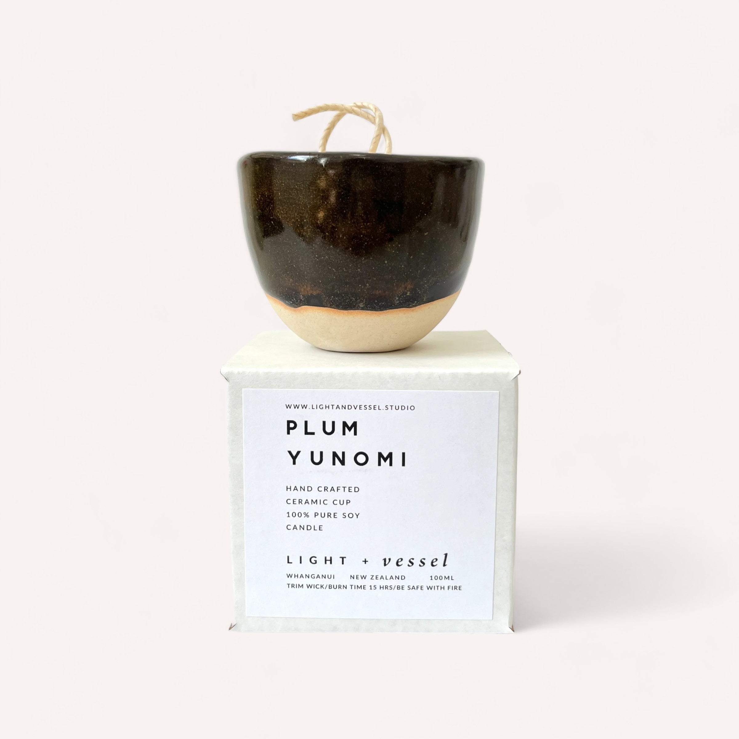 Handcrafted Plum Candle by Light + Vessel soy candle with natural fragrance oils displayed on minimalist packaging with a descriptive label.