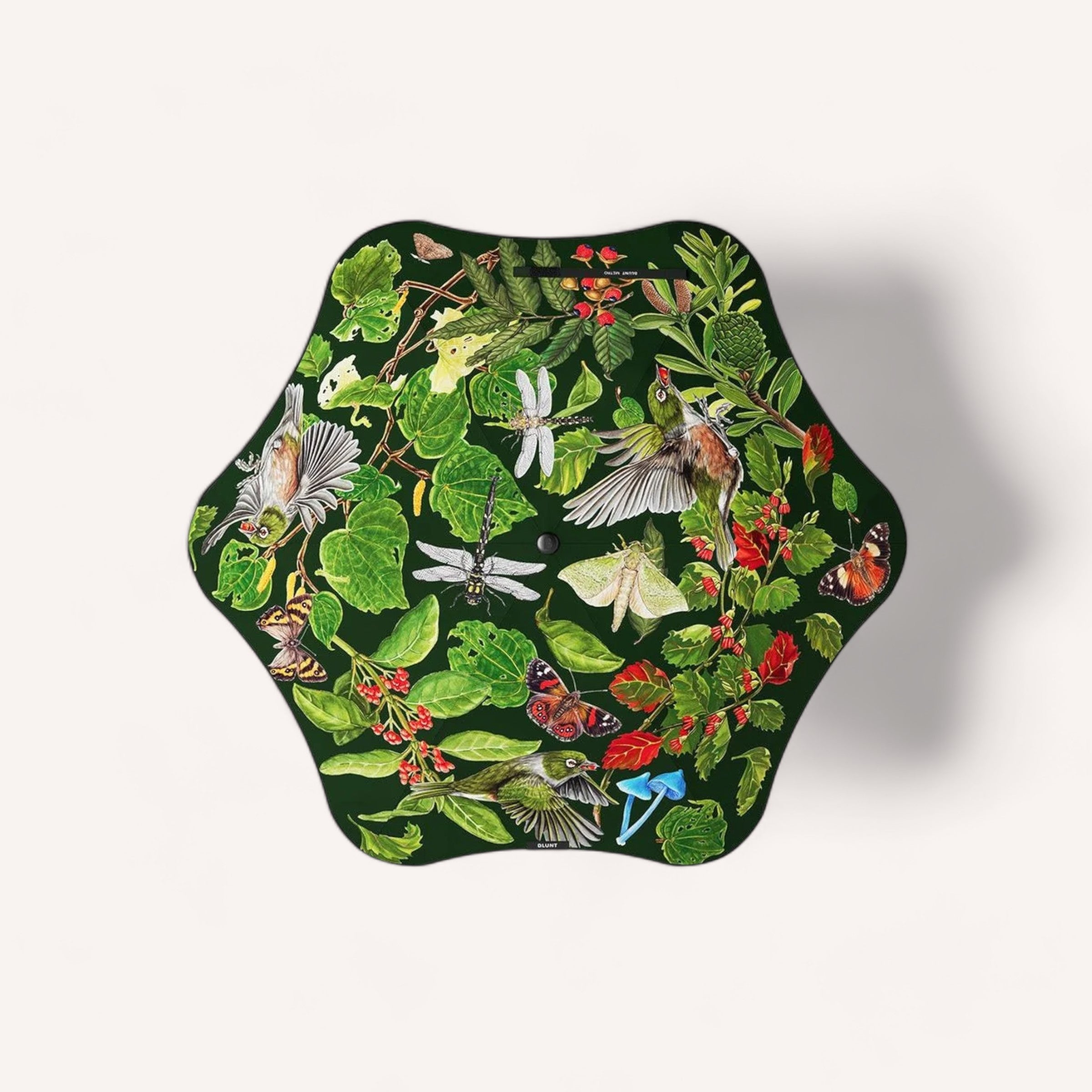 A BLUNT Metro Umbrella Forest & Bird - Limited Edition with a hexagon-shaped design and a vividly colored nature illustration, showcasing an array of flora and fauna including birds, butterflies, and lush green leaves on a white background.
