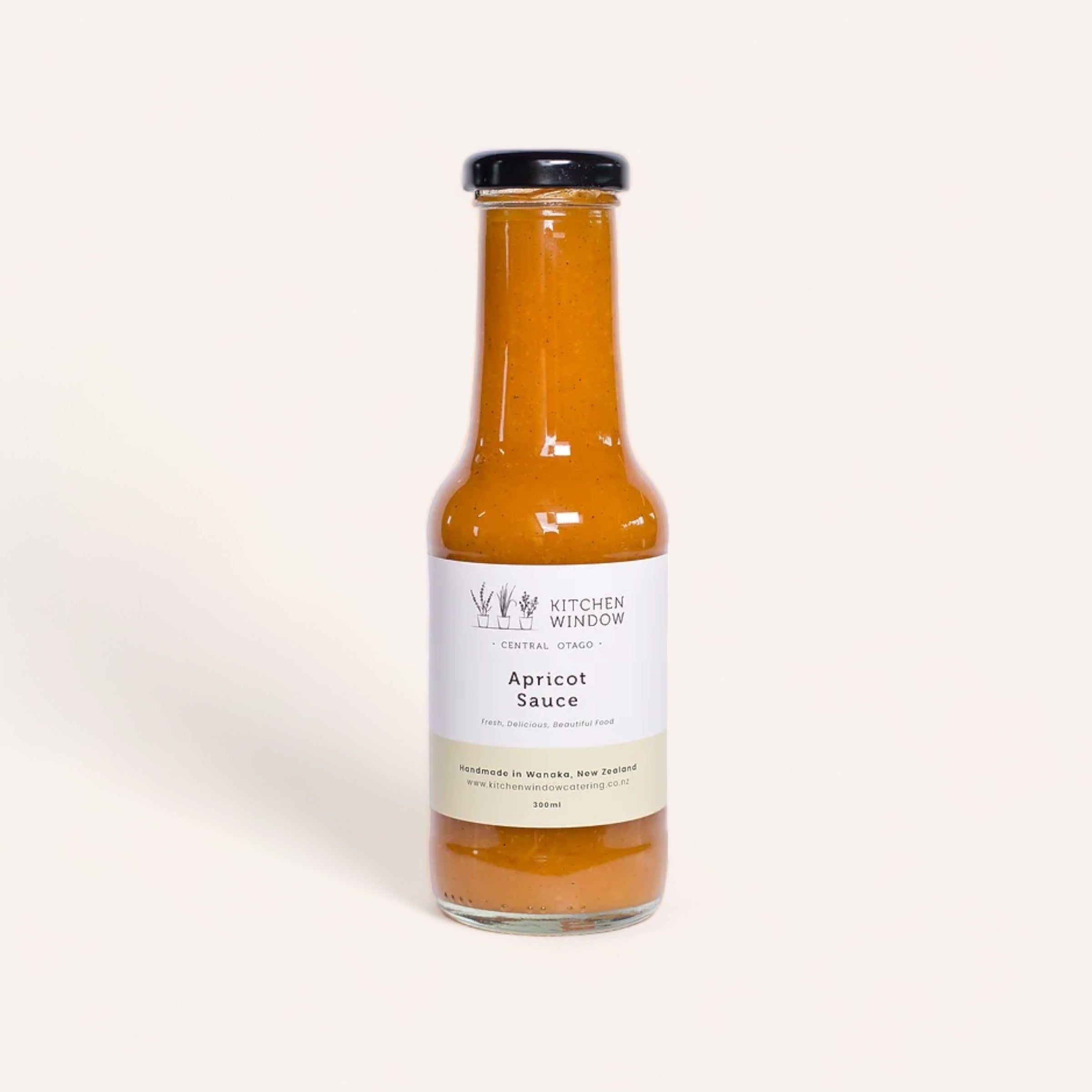A bottle of Apricot Sauce by Kitchen Window made with Central Otago apricots from Kitchen Window brand against a clean, white background.