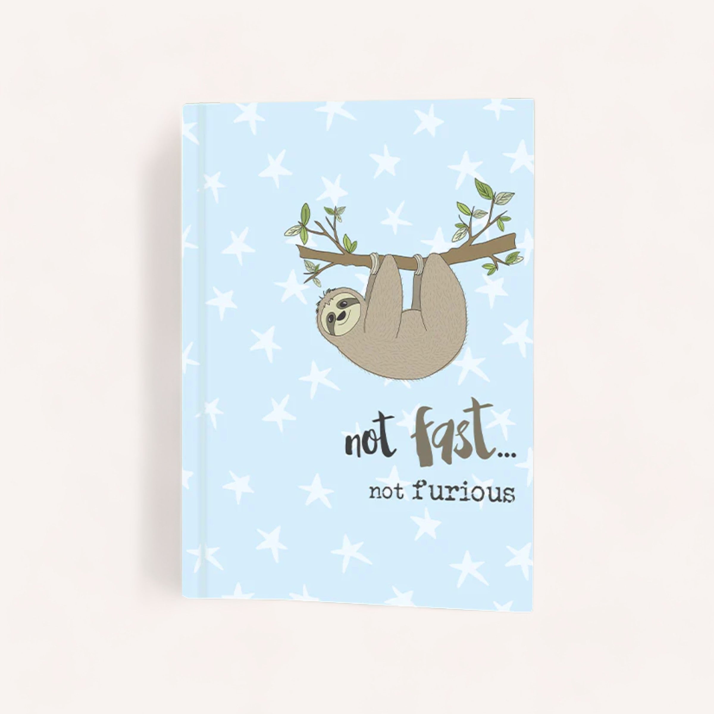 A serene blue Dandelion Not fast, Not furious Notepad featuring a cute illustration of a sloth hanging from a branch with the playful words "not fast... not furious" below it, surrounded by a pattern of stars.