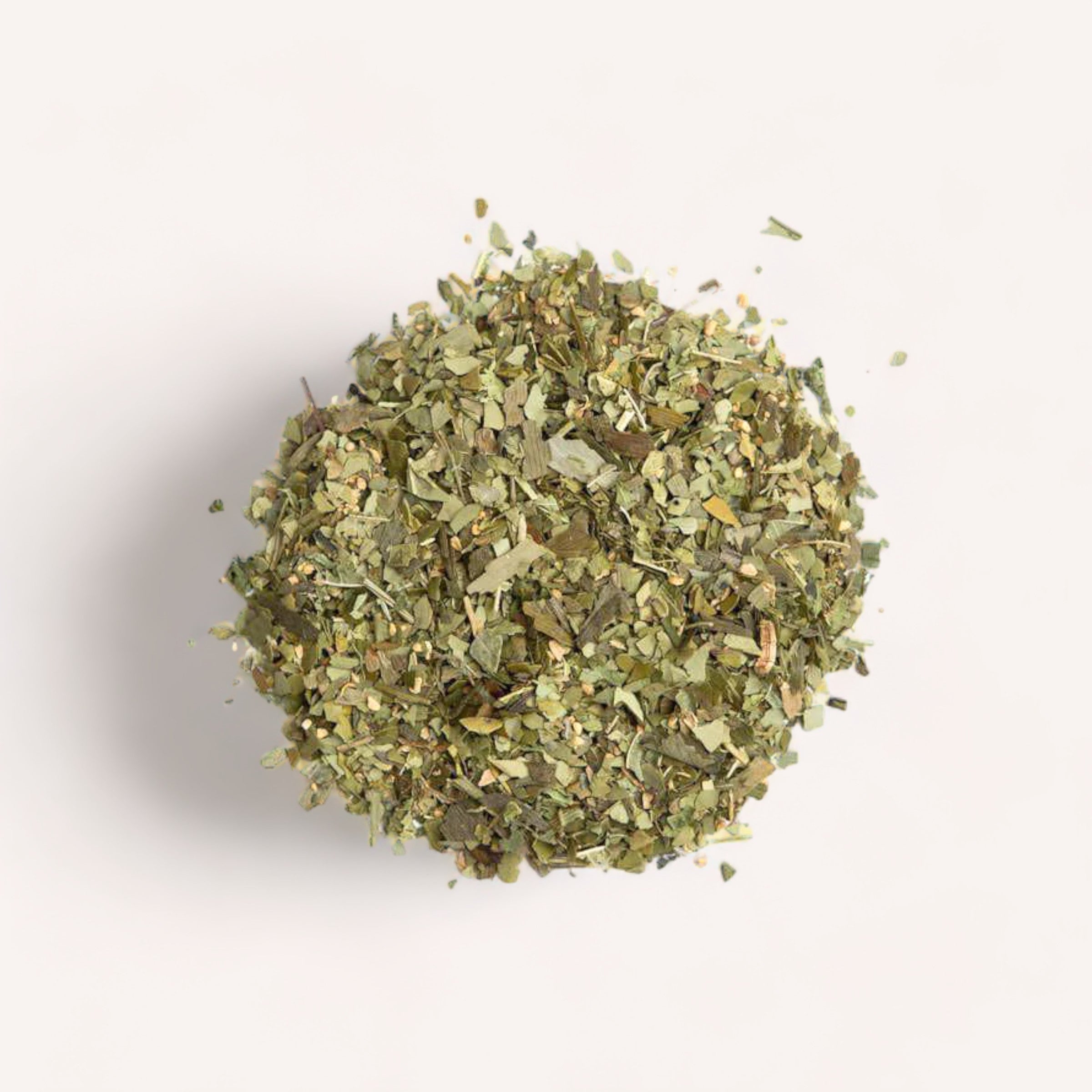A pile of dried Clarify Tea herbs by Forage + Bloom against a white background.