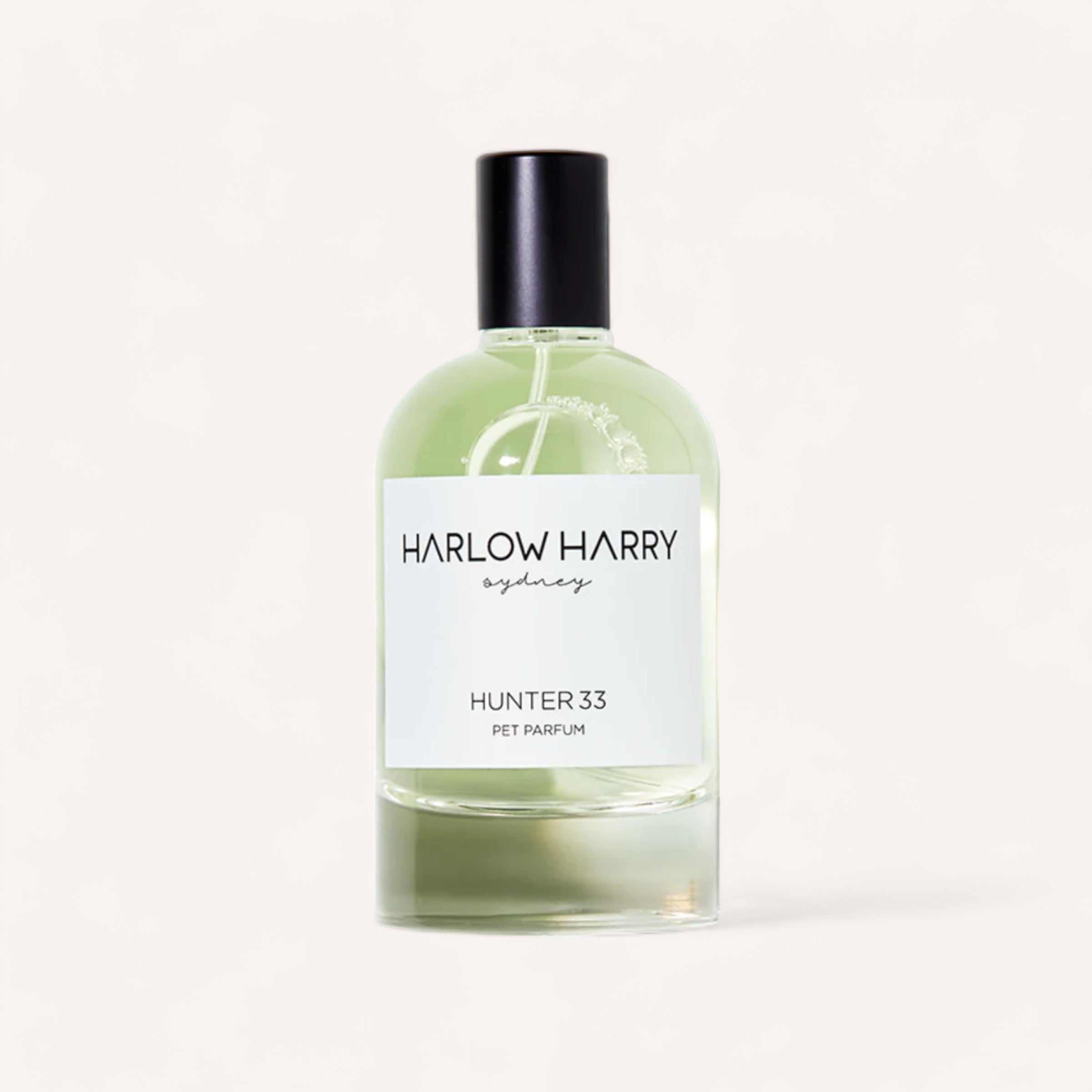Elegant Hunter 33 Dog Perfume bottle with a clear, green-tinted liquid and a simple, chic label that reads "Harlow Harry Sydney, Hunter 33" - a unisex scent for dogs.