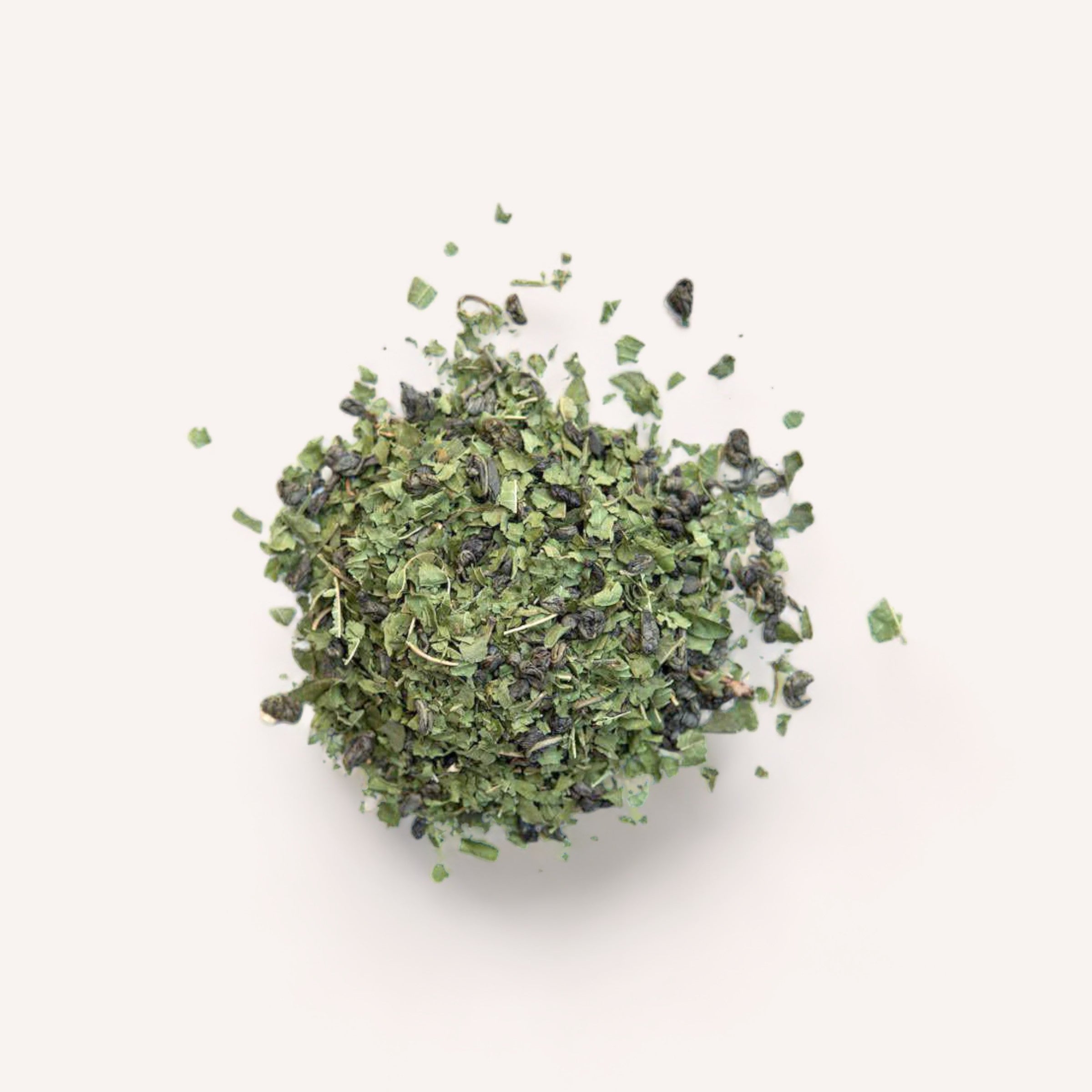 A neat pile of dried Revive Tea herbs by Forage + Bloom, rich in antioxidants and known to stimulate metabolism, isolated on a white background.