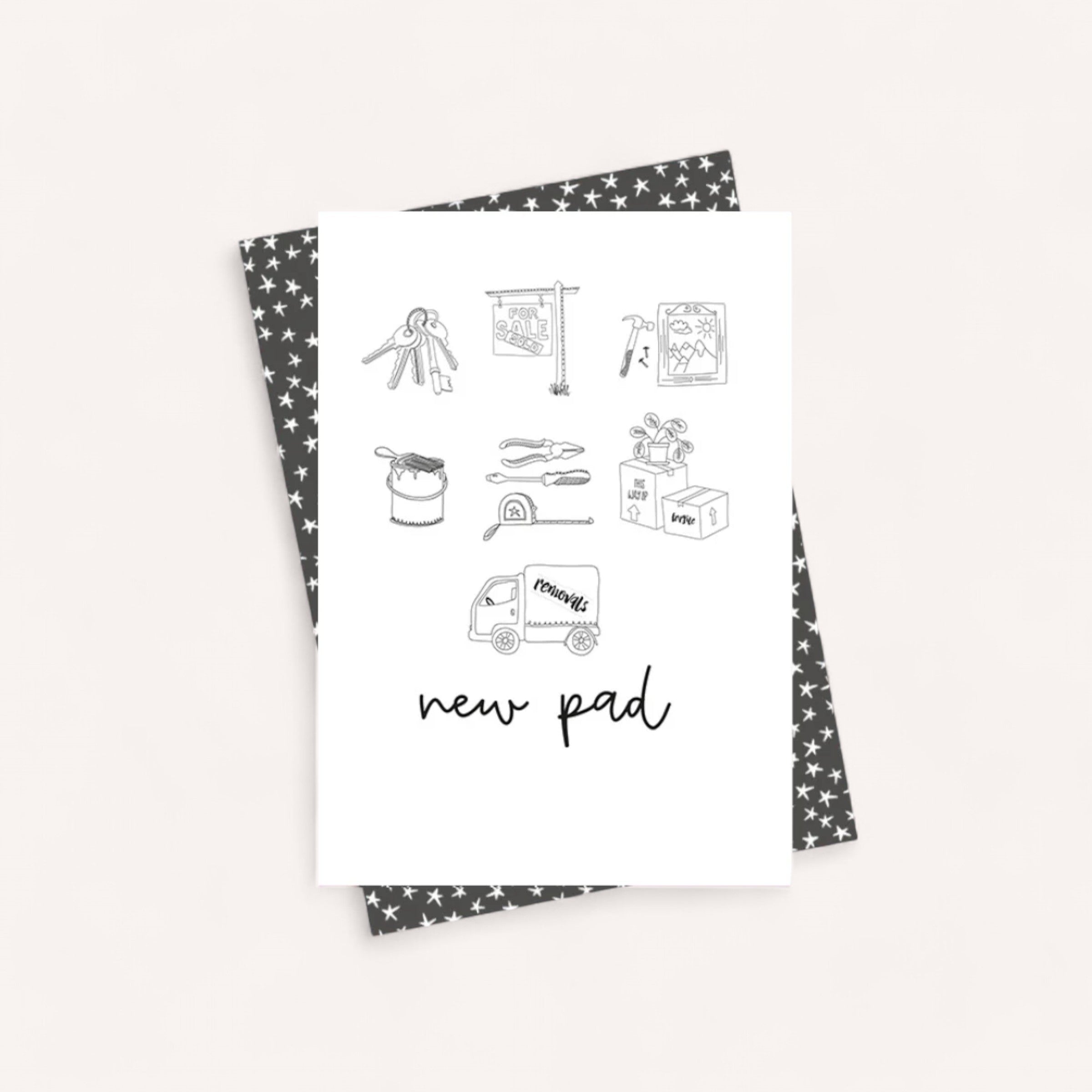 Introducing the New Pad Card from Dandelion: This card is set against a star-patterned background and includes the words "new pad." It showcases minimalistic illustrations of house keys and a moving truck. The interior is blank, allowing you to add your personal message. Paired with a patterned envelope, it’s perfect for those looking to purchase in multiples when celebrating new beginnings.