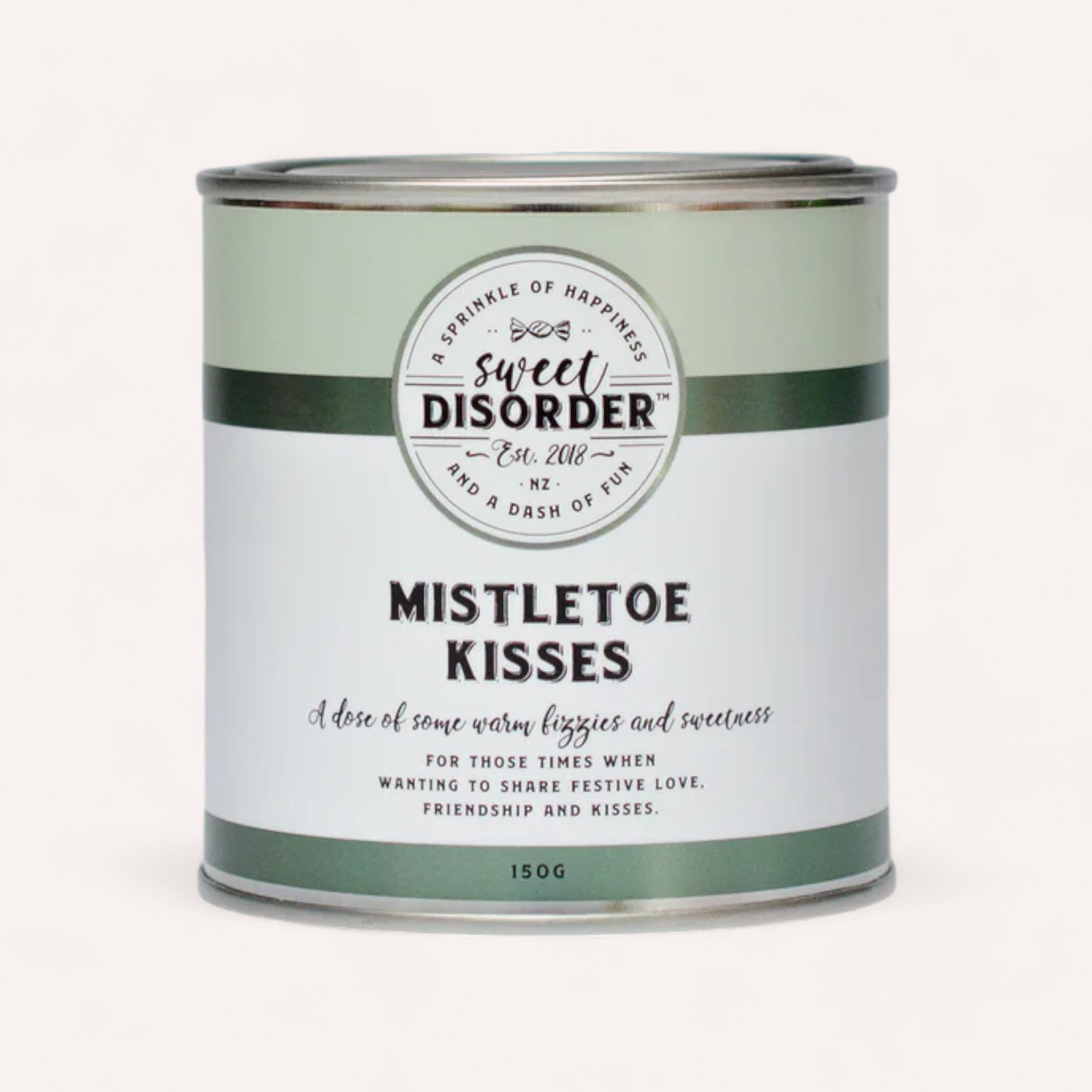 A 150g green tin from Sweet Disorder prominently displays the words "Mistletoe Kisses" at the top. The description below reads, "A dose of some warm fuzzies and sweetness for those times when festive love, friendship, and granny mints abound.