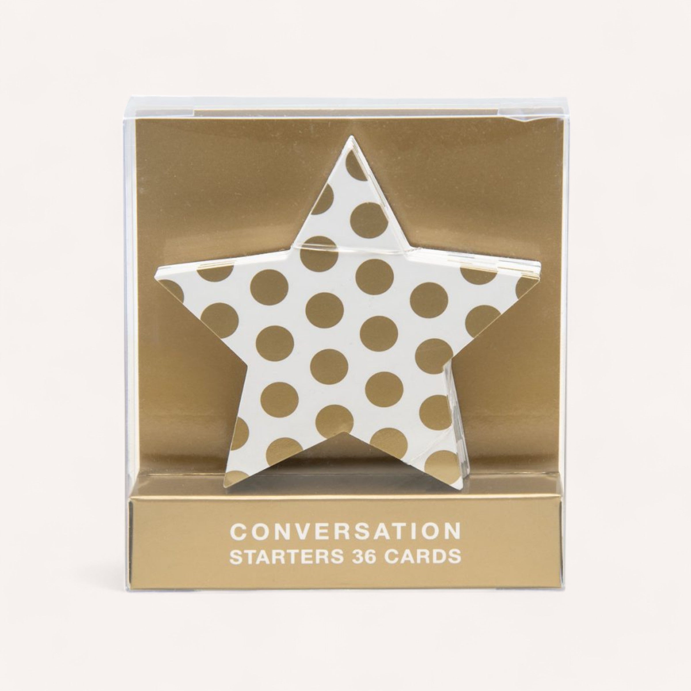 The Christmas Conversation Starters Cards by giftbox co. make an ideal holiday gift, featuring 36 elegantly designed cards displayed in a star-shaped holder adorned with gold polka dots on a white background. The predominantly gold packaging prominently showcases "CONVERSATION STARTERS 36 CARDS" at the bottom, making them perfect for Christmas parties.