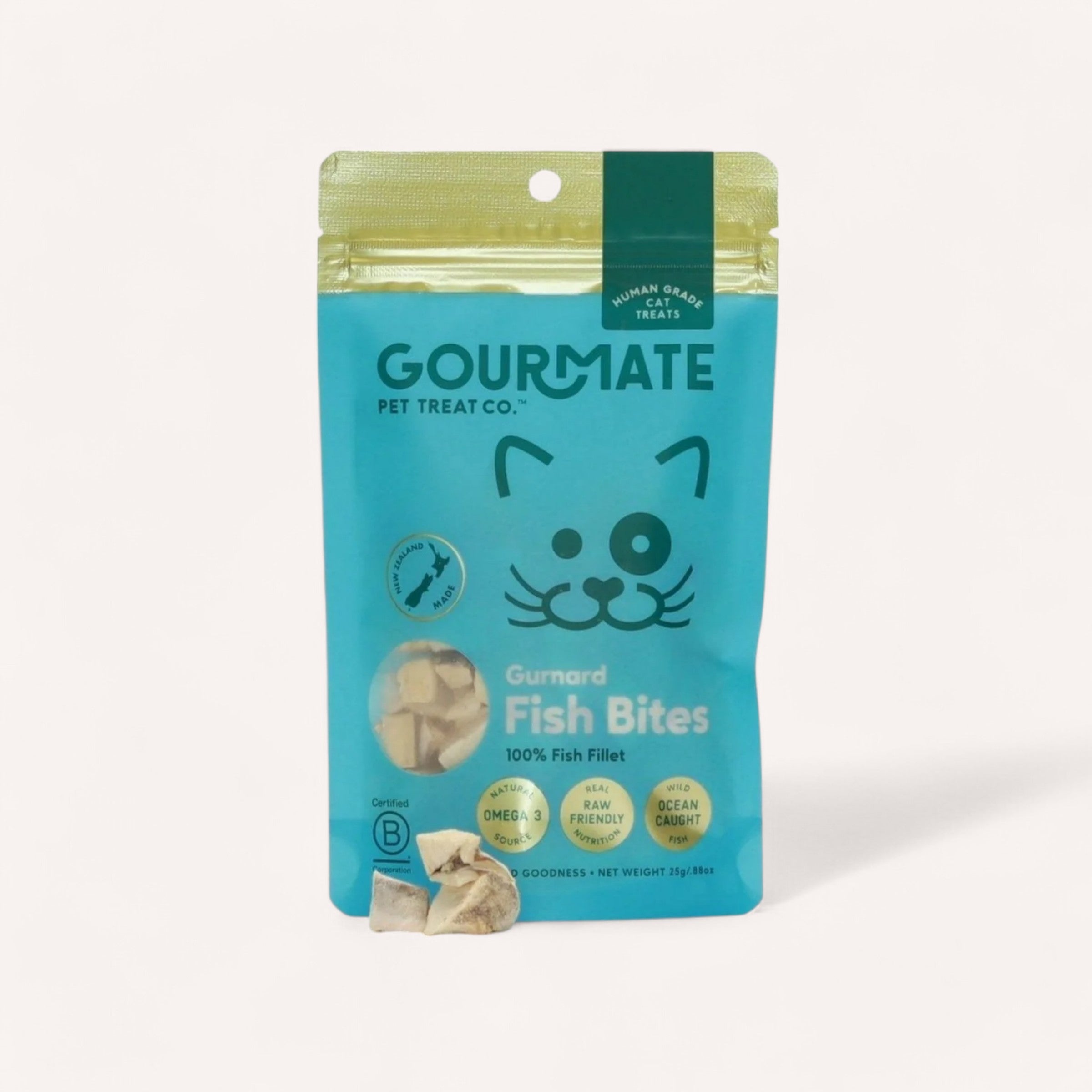 Gourmate Pet Treat Co. presents Cat Treats by Gourmate in a turquoise package adorned with a delightful cat illustration. These treats highlight "100% Fish Fillet" and "Omega 3," making them an ideal choice for raw feed diets. The ocean-caught gurnard fish bites are perfectly complemented by green-lipped mussels, with small fish pieces prominently displayed on the front of the bag.