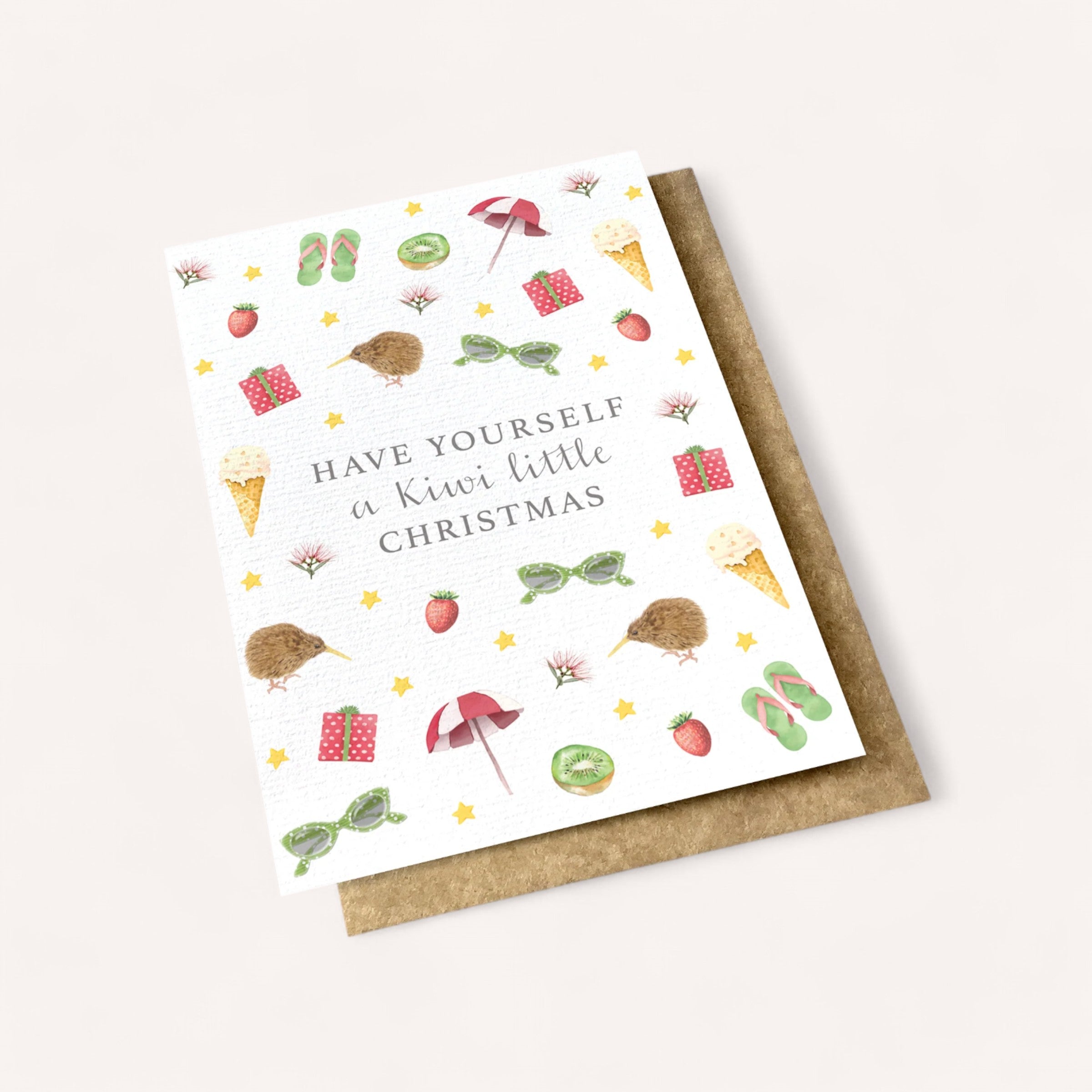 Celebrate the holidays with Ink Bomb's Kiwi Christmas Card, featuring the phrase "Have Yourself a Kiwi Little Christmas" adorned by charming illustrations of kiwis, ice cream cones, strawberries, sunglasses, flip-flops, gifts, beach umbrellas, stars, and beach balls. The card is blank inside and comes with a white envelope—ideal for sending warm holiday wishes to your loved ones in style!