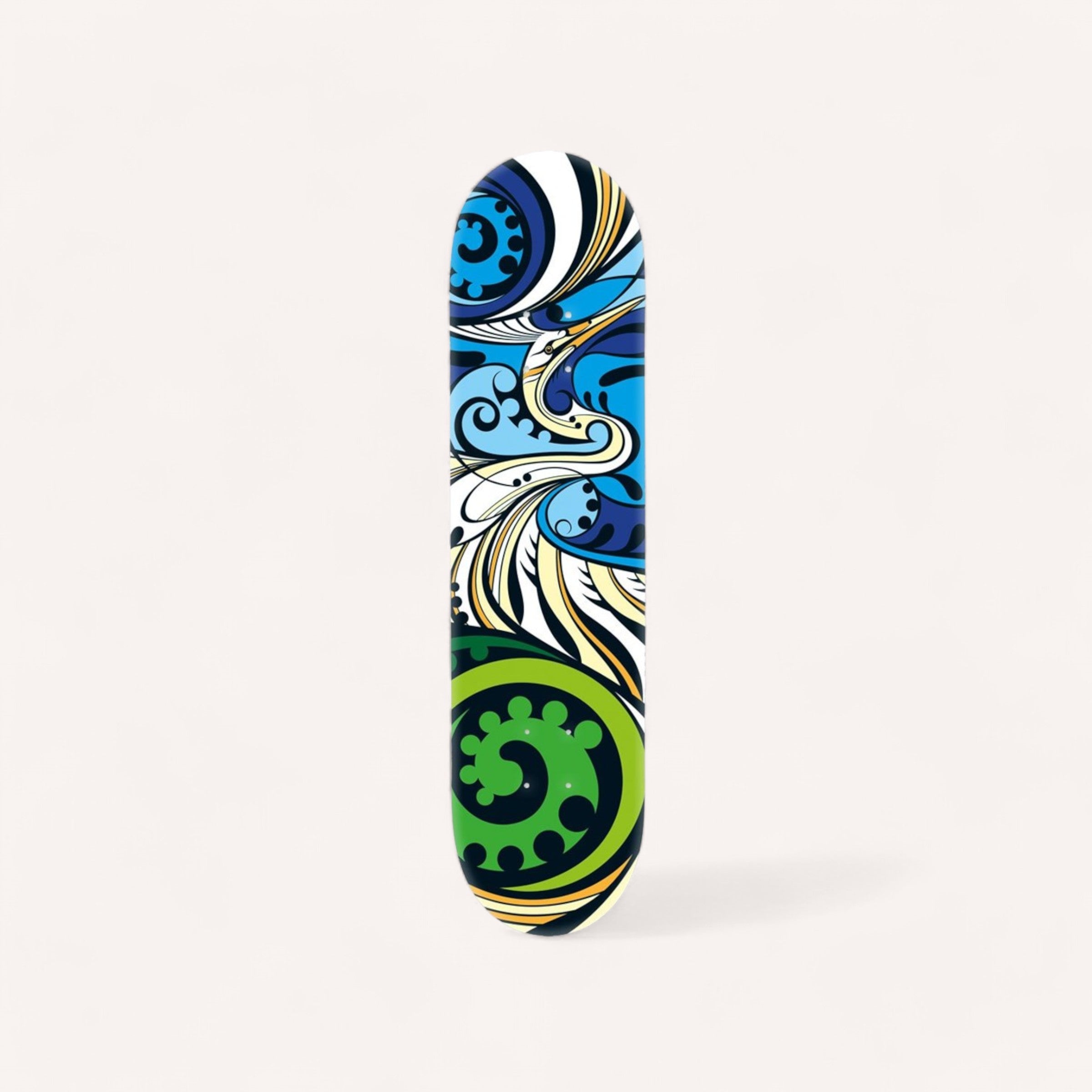 The Kotuku Skateboard Deck, created by New Zealand artist Shane Hansen and crafted from a Canadian maple deck, showcases an abstract design. The dynamic artwork features swirling blue and green patterns with circular shapes and wave-like forms set against a white background, offering an eye-catching visual effect.