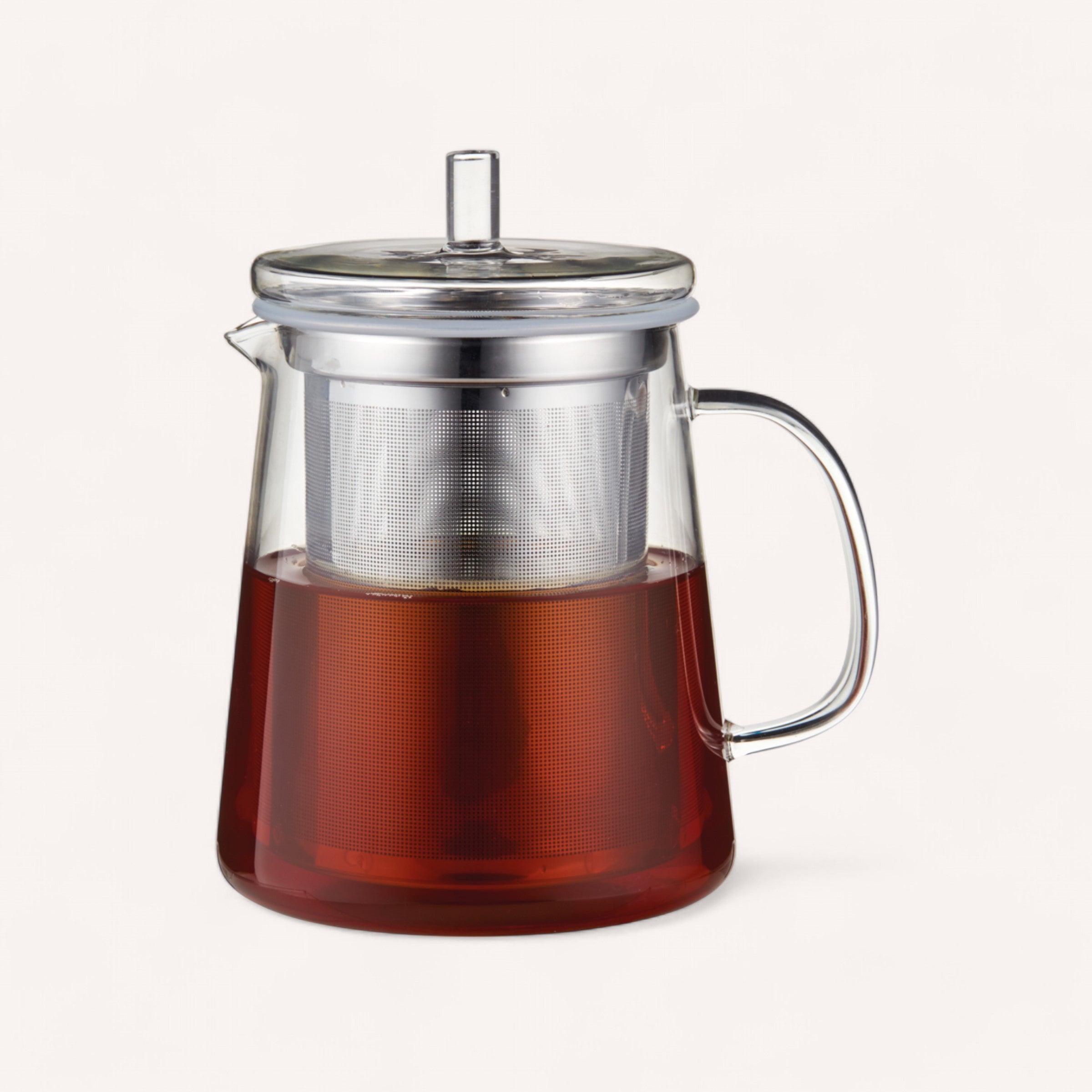 Giftbox Co.'s "Tea for Two" is a clear glass teapot featuring a sleek metal lid and handle, embodying a minimalist design that's perfect for steeping a rich amber hue with its internal metal infuser. The stylish teapot stands out beautifully against the plain white background.