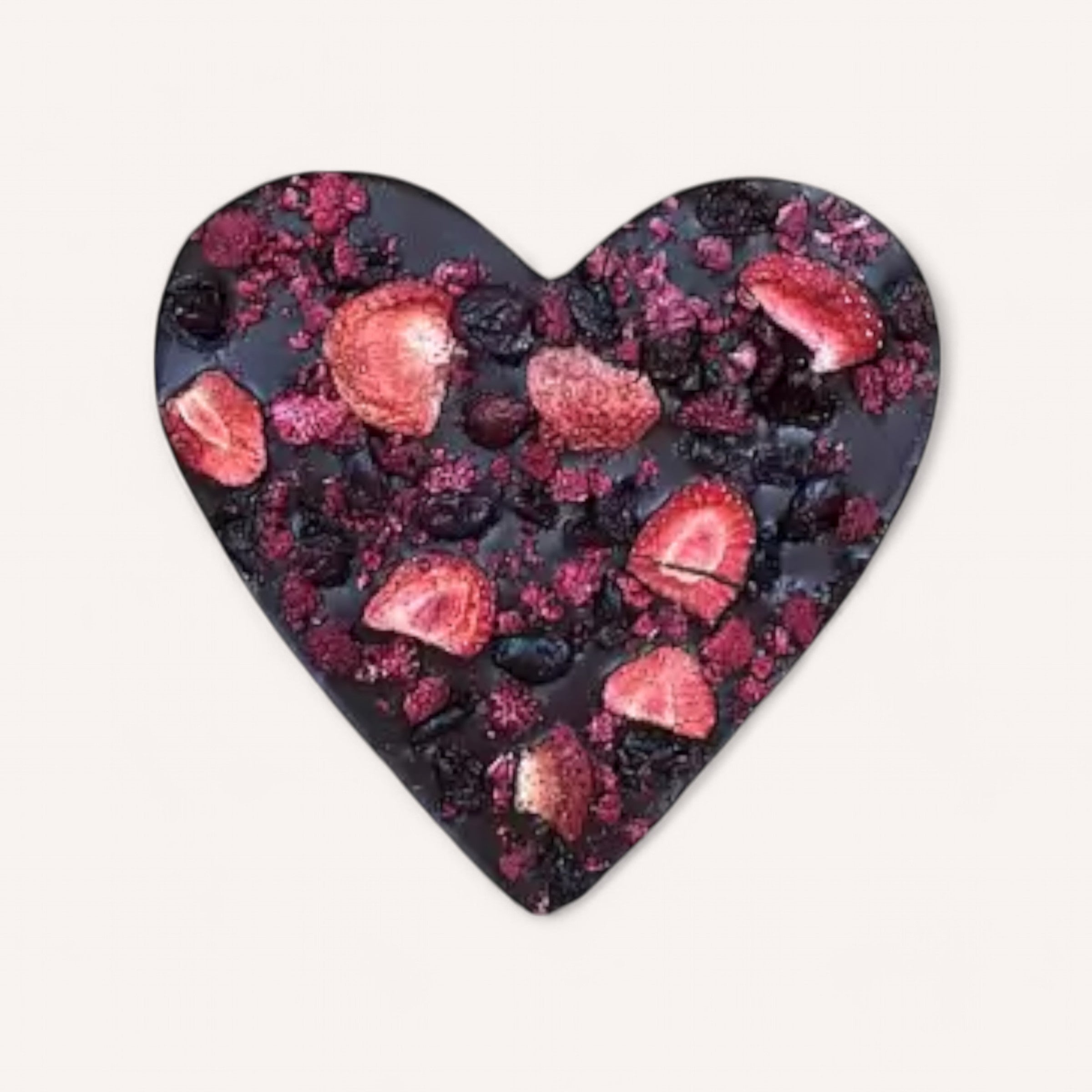 **Mindful Moments by giftbox co.** features heart-shaped dark chocolate adorned with vibrant dried strawberries, blueberries, and raspberries. The rich chocolate offers a beautiful contrast to the colorful fruit pieces, creating an artistic delight that perfectly suits a self-care gift box against a plain white background.