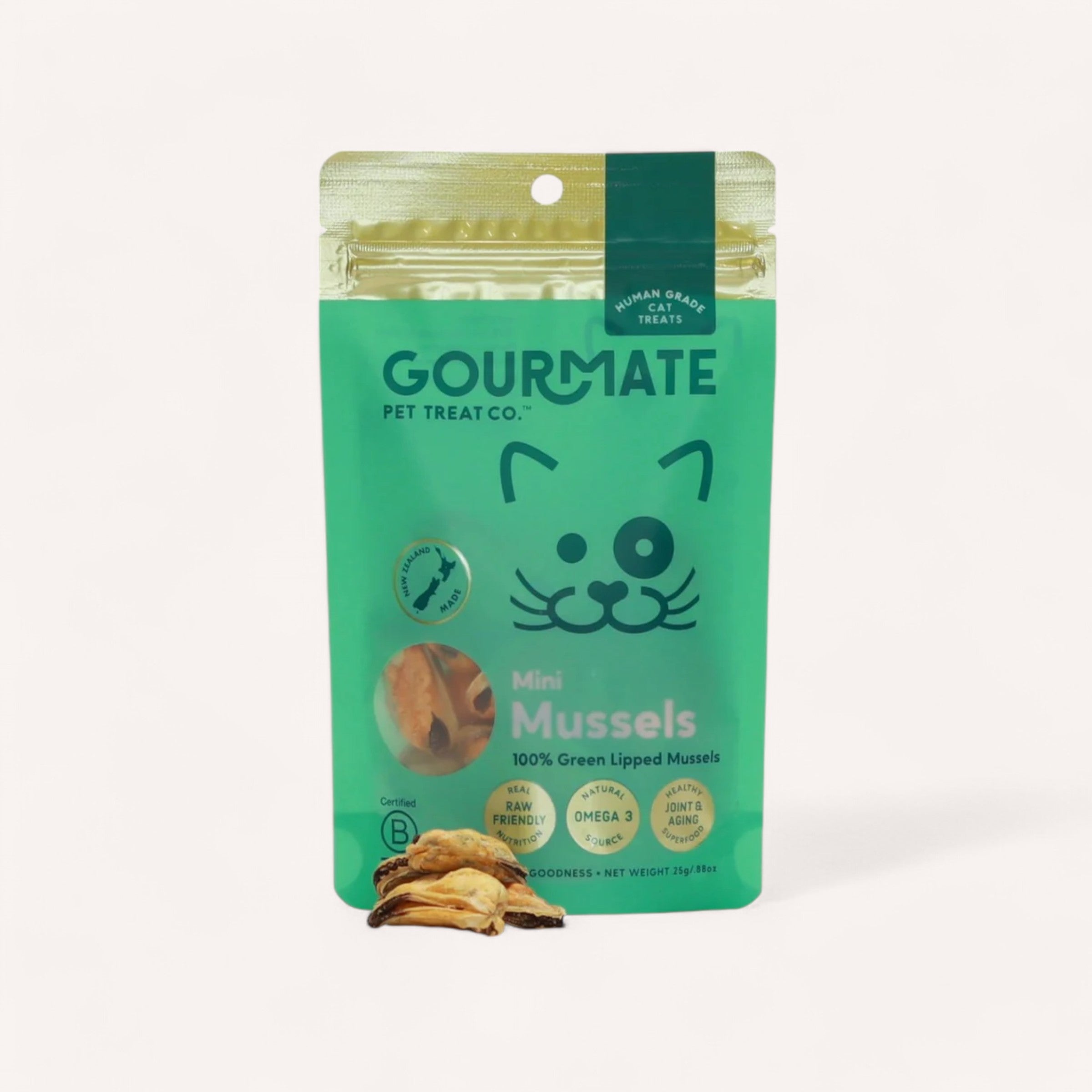 A pouch from Gourmate Pet Treat Co., featuring a cute cat face, contains their Cat Treats made from 100% green-lipped mussels. The packaging proudly highlights that the treats are human-grade, raw, and omega-rich. At the bottom, three loose mussels exemplify their quality.