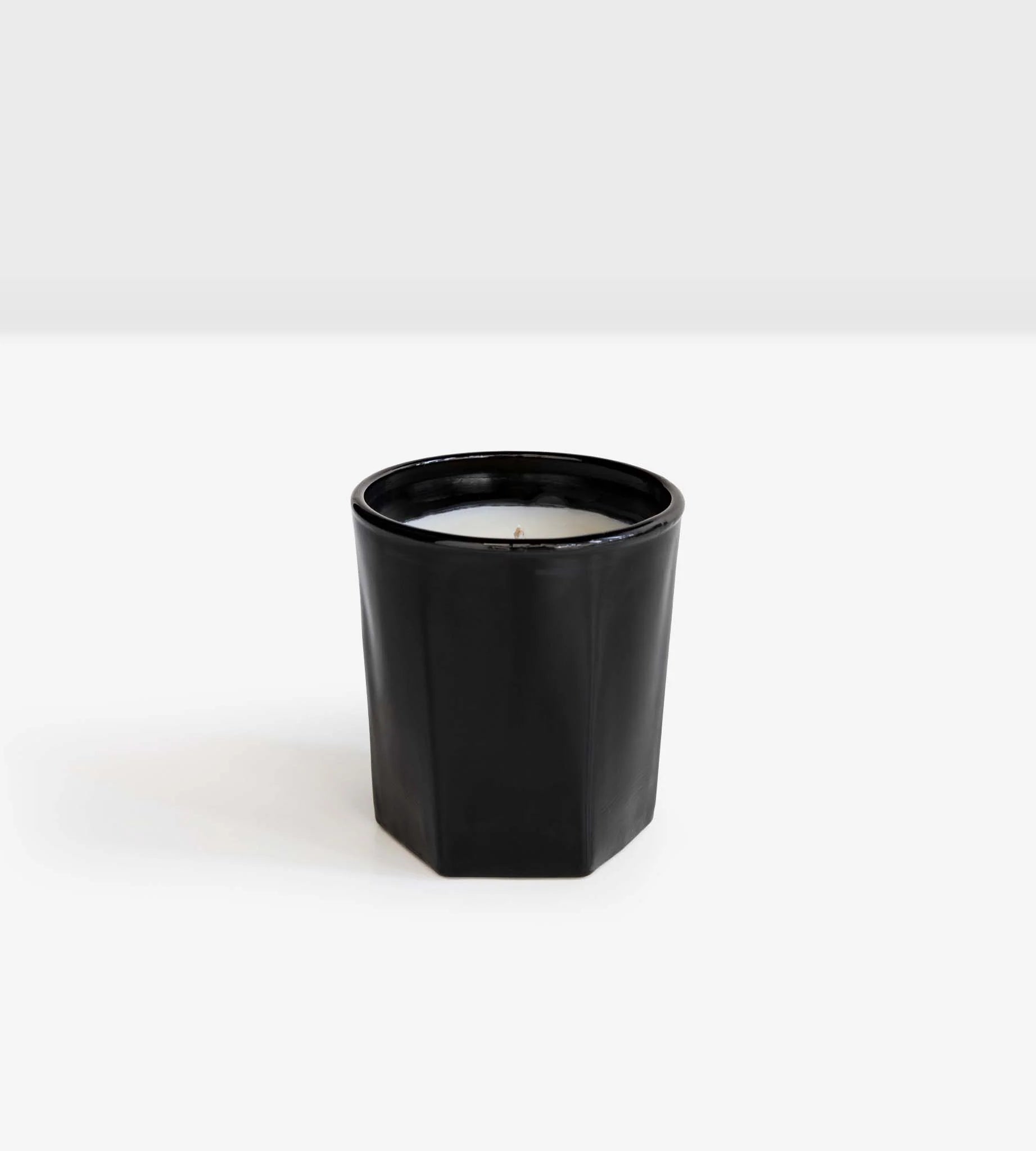 A handcrafted Amipere & Moss Bark Candle by Real World in a minimalist design against a white background.