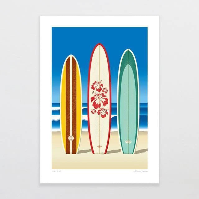 The artwork "Surf's Up by Glenn Jones," from the brand Glenn Jones, depicts three surfboards standing upright on a sandy beach. From left to right, there is a brown board with orange stripes, a white board adorned with red hibiscus flowers, and a teal board. The ocean and blue sky provide a scenic backdrop.