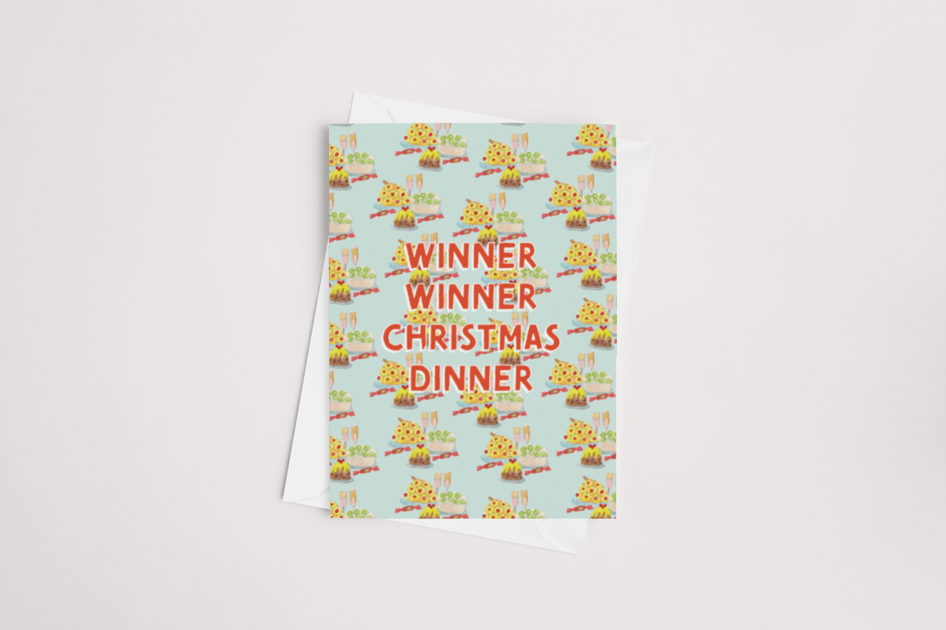 Introducing the "Winner Winner Christmas Card" by Tuesday Print: This charming greeting card comes with a white envelope and showcases a festive pattern of Christmas dinners, including roast turkeys and puddings, set against a light blue background. Bold red letters proclaim "WINNER WINNER CHRISTMAS DINNER," and the card provides ample space inside for your personal holiday message. It's an ideal choice for the festive season!